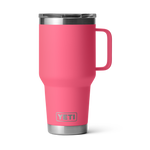Product photography, YETI, of a vibrant hot pink Rambler Travel Mug with a clear MagSlider lid, sturdy integrated handle, and engraved silver YETI logo on its brushed stainless steel base, isolated against a black background