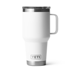 Product photography by YETI featuring a white Rambler 30 oz travel mug with a large handle a clear MagSlider lid and silver YETI logo accents on a black background