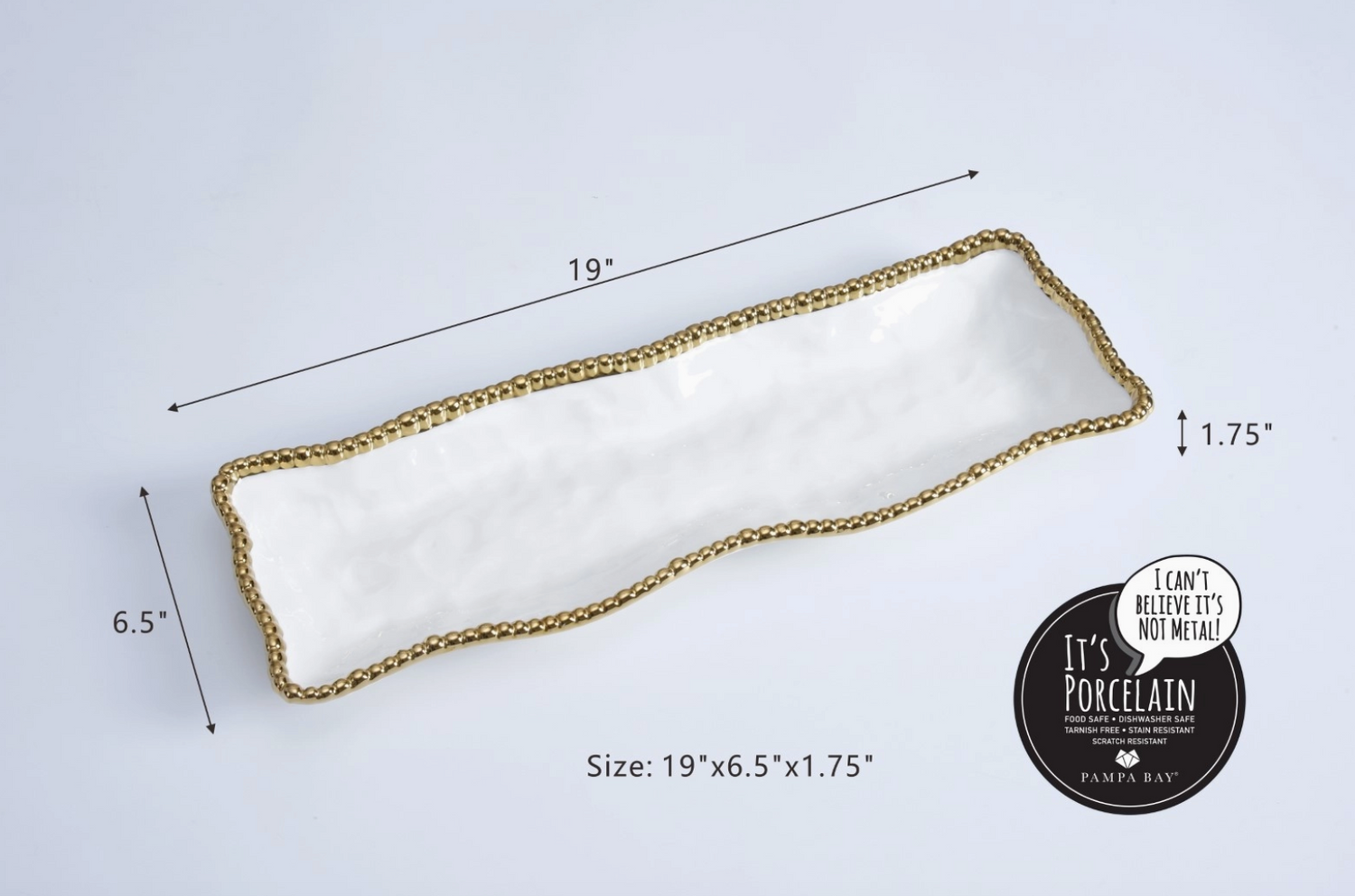 Pampa Bay porcelain rectangular serving tray featuring a white wavy texture gold beaded rim and measuring 19x6.5x1.75 inches