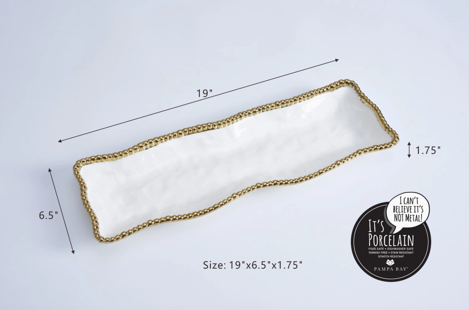 Pampa Bay porcelain rectangular serving tray featuring a white wavy texture gold beaded rim and measuring 19x6.5x1.75 inches