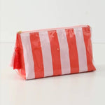 Plastic rectangular glossy cosmetic pouch with bold vertical coral red and white stripes and a two-tone pink and red tassel zipper pull