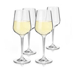 Four clear stem wine glasses on a white background, two filled with pale yellow white wine and two empty, reflecting on the surface