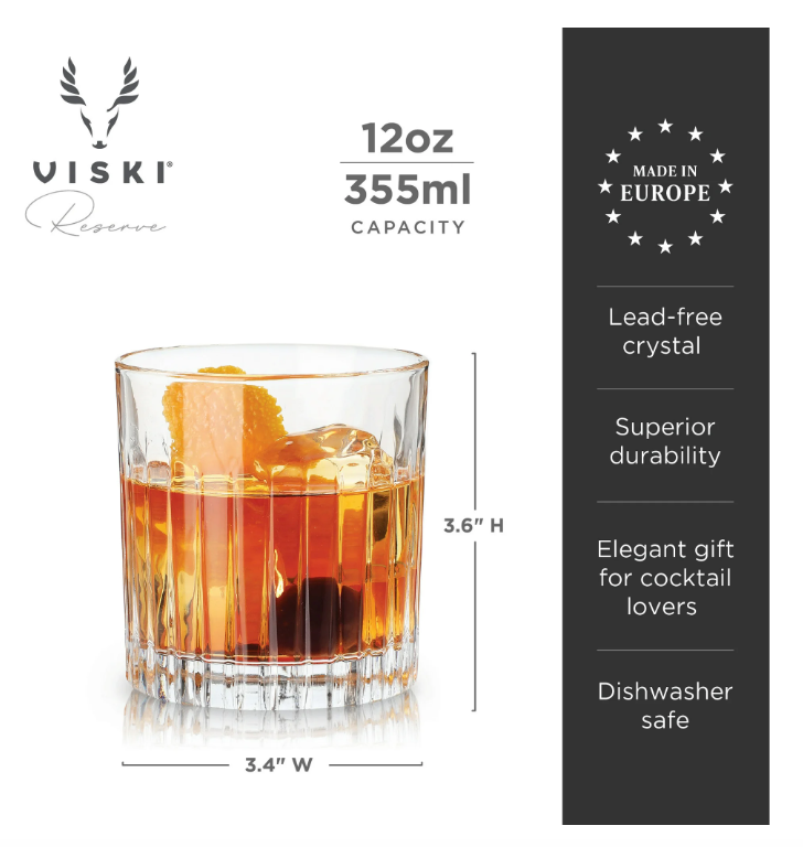 Viski Reserve fluted lead-free crystal old fashioned glass holding an amber cocktail with ice, a vibrant orange peel, and a dark cherry, highlighting its 12oz capacity and Made in Europe craftsmanship