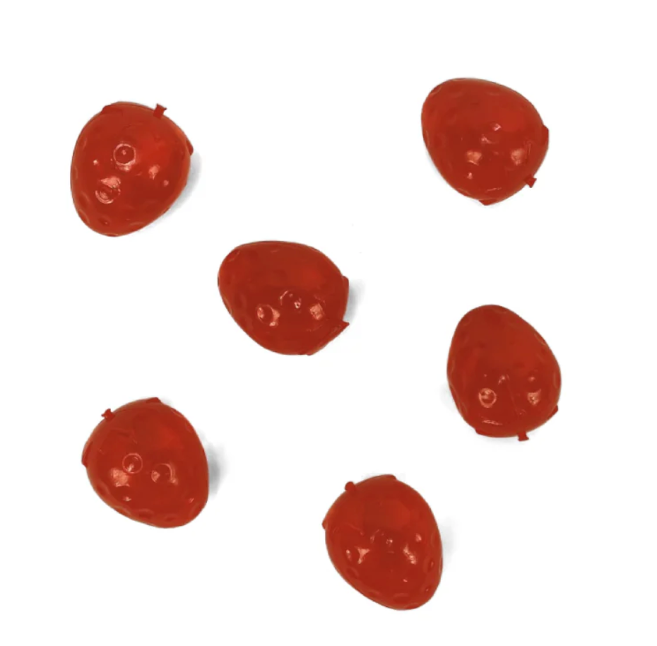 Five red plastic strawberry shaped beads on a white background