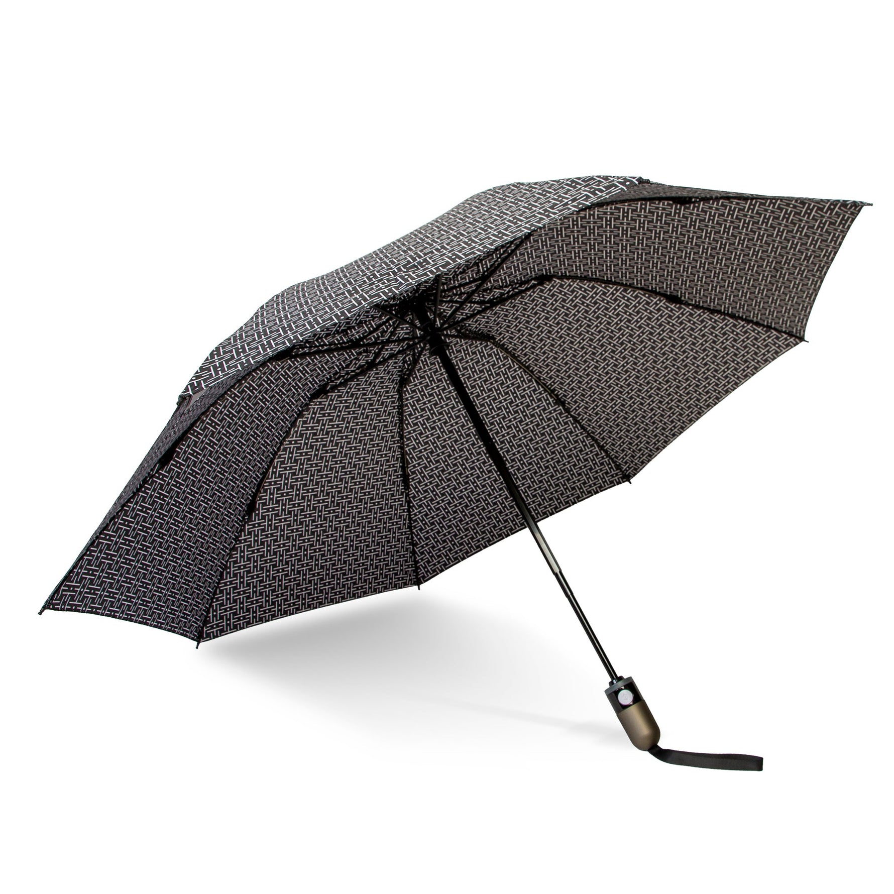 An opened umbrella with a black and white geometric interlocking H-pattern canopy, featuring a dark gray handle with a black wrist strap, presented on a white studio background