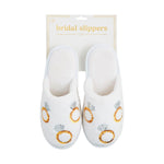 A pair of white plush bridal slippers featuring multiple gold and silver sequin engagement ring designs displayed in L/XL packaging against a white background