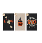 Three glow-in-the-dark Halloween themed decorative textile panels depicting an orange 'Spooky' with white rope ghosts on black fabric, an orange rope pumpkin with a black witch hat on beige fabric, and an orange 'Boo' over a white spiderweb on black fabric