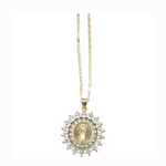 Gold necklace featuring an oval Virgin Mary medallion encircled by brilliant clear cubic zirconia stones in a radiant sunburst design on a delicate gold chain