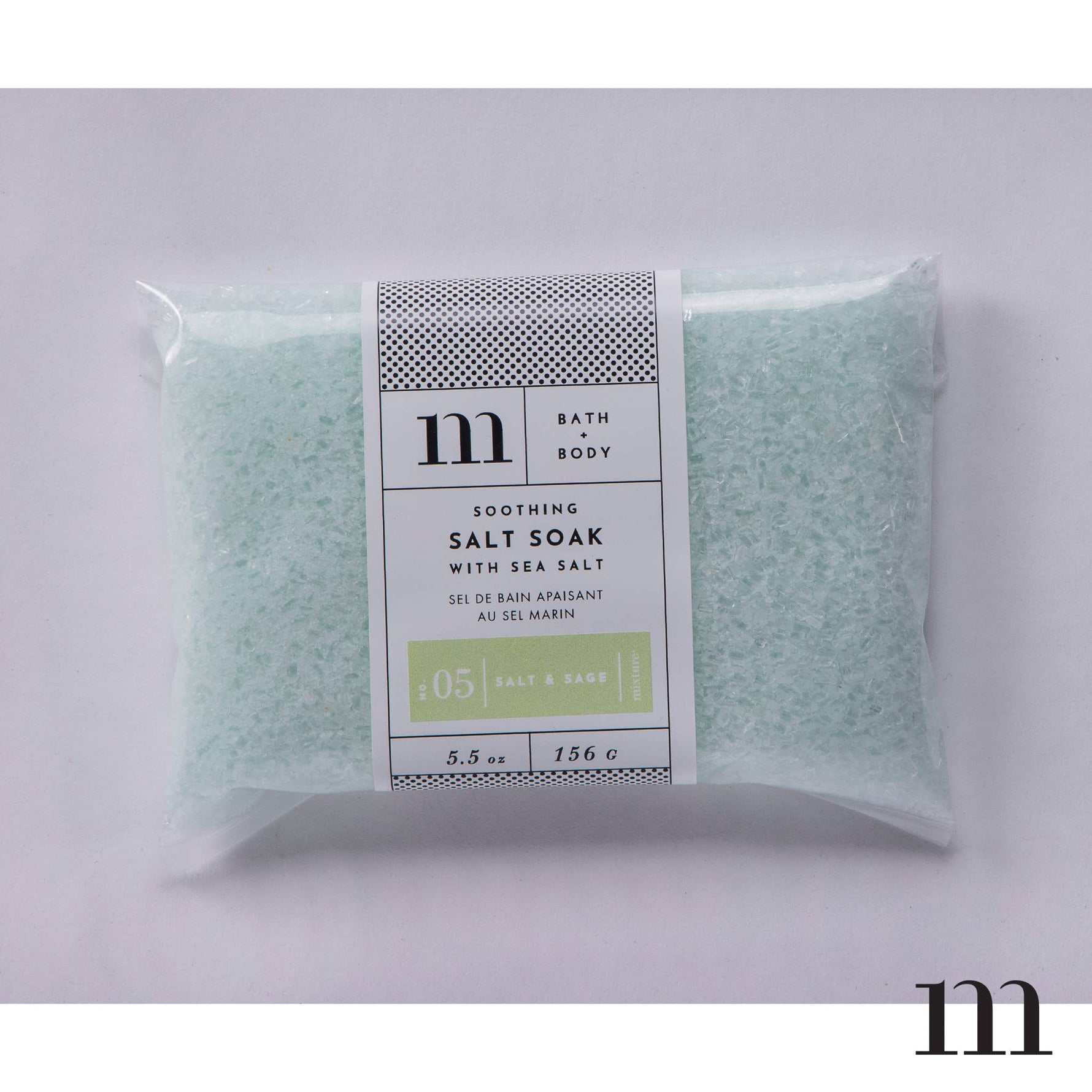 Clear plastic bag of light green bath salt soak with Mixture brand label