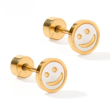 A pair of gold-toned stud earrings with white circular faces featuring a simple gold smiley face design