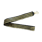 Black and gold sequined strap featuring sparkling striped patterns and a golden metal clasp presented folded in a V-shape