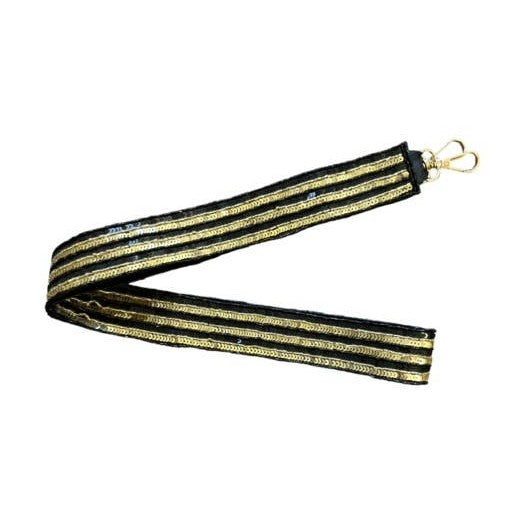 Black and gold sequined strap featuring sparkling striped patterns and a golden metal clasp presented folded in a V-shape