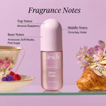 Product photograph of Kitsch Sheer Violet Hair Perfume bottle on a glass shelf, surrounded by a vintage floral teacup with raspberries, an almond croissant, and text detailing fragrance notes including Almond, Raspberry, Orris Italy, Violet, Ambroxan, Soft Musks, and Pink Sugar, all on a light purple background