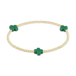 Gold beaded bracelet with three vivid green cross-shaped charms
