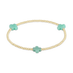 Jewelry: Delicate gold beaded bracelet adorned with three mint green cross-shaped charms