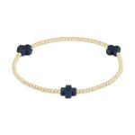 Gold beaded stretch bracelet featuring three dark blue cross-shaped charms on a white background