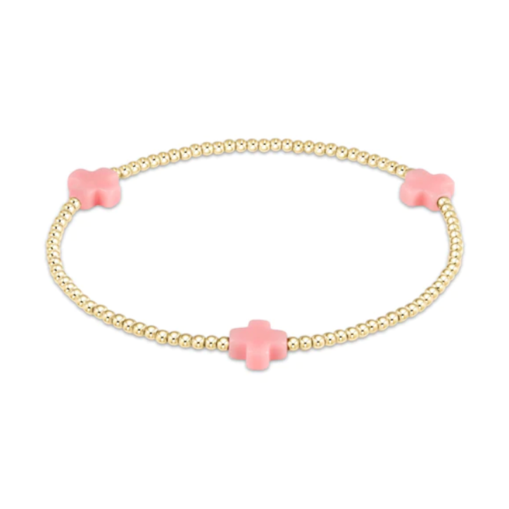 Gold beaded bracelet featuring tiny gold beads and three soft pink cross charms