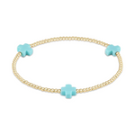 Dainty gold beaded bracelet featuring three vibrant turquoise cross charms