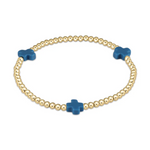 A stretch bracelet crafted from small gold beads featuring three vibrant blue cross-shaped charms