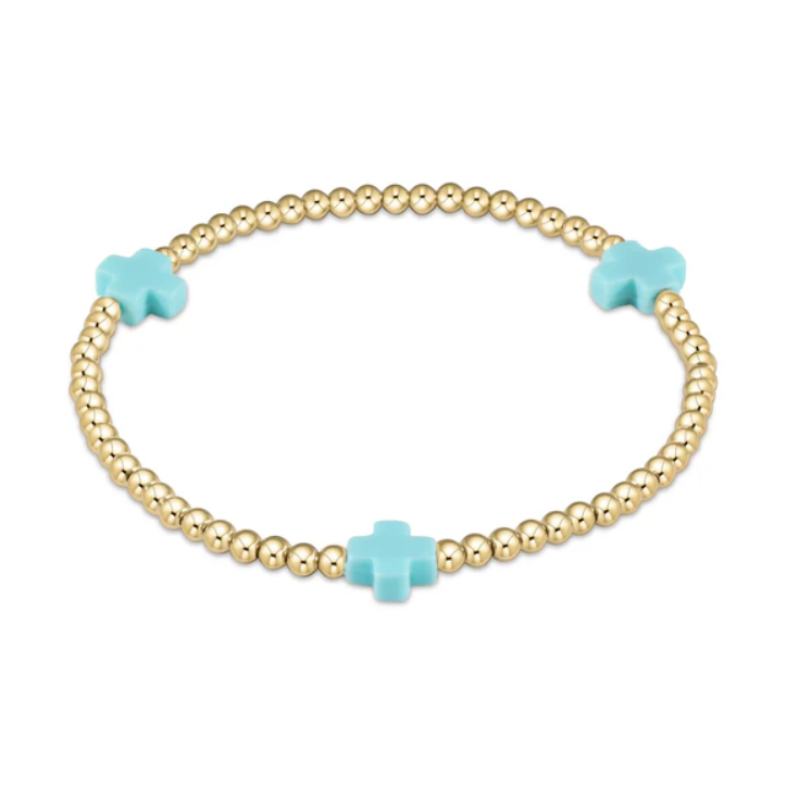 Gold beaded jewelry bracelet with three light blue cross charms