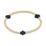 Jewelry: A sleek gold beaded bracelet featuring three dark blue matte cross charms