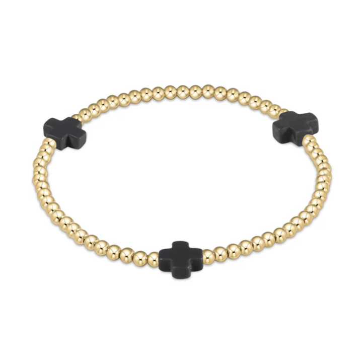 Gold beaded bracelet with three distinctive black cross charms