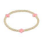 A delicate gold beaded bracelet featuring three evenly spaced pastel pink cross-shaped accents