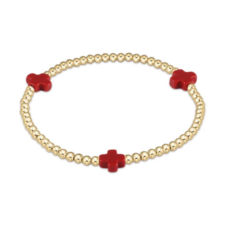 Gold beaded bracelet featuring three vibrant red cross-shaped charms