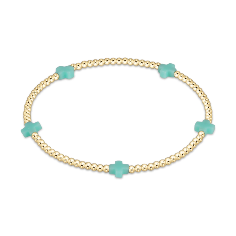 Gold beaded stretch bracelet with four turquoise cross charms
