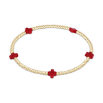 Gold beaded stretch bracelet with red cross shaped accents
