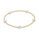 Gold beaded stretch bracelet with four white cross charms