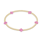 Gold beaded bracelet with four pink cross charms