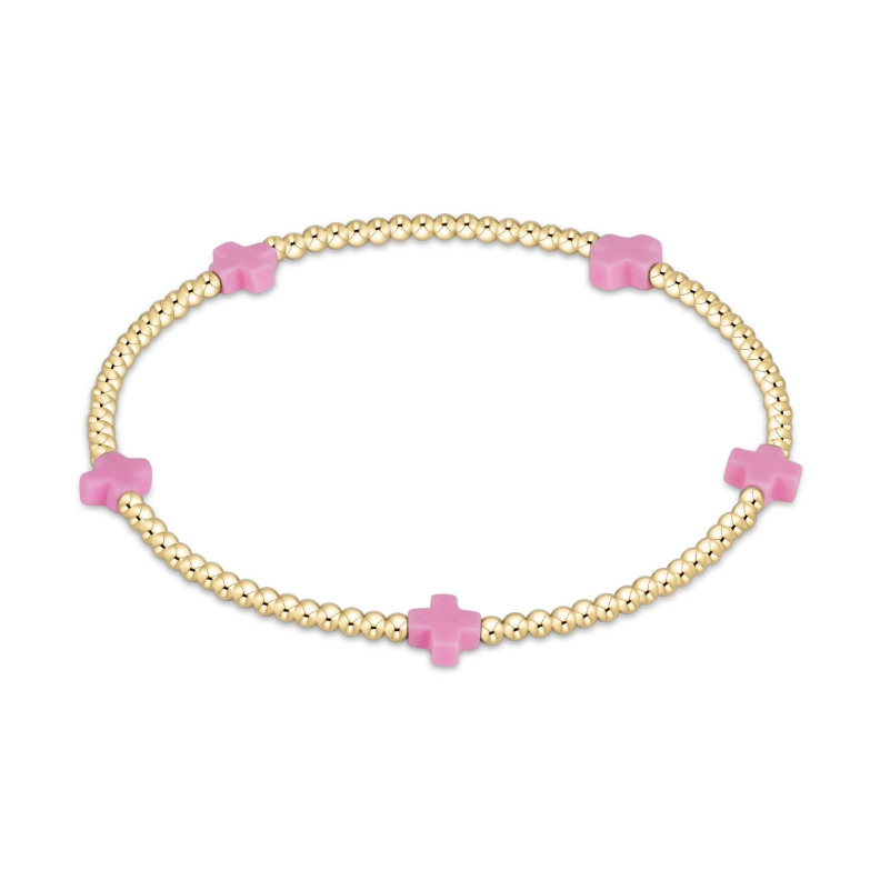Gold beaded bracelet with four pink cross charms