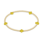 Gold beaded stretch bracelet with four yellow cross charms