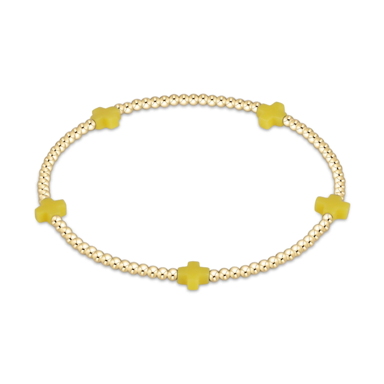 Gold beaded stretch bracelet with four yellow cross charms