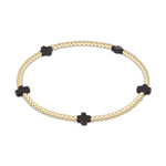 Gold beaded stretch bracelet with four black cross shaped beads