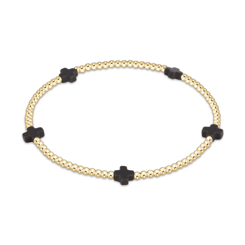 Gold beaded stretch bracelet with four black cross shaped beads