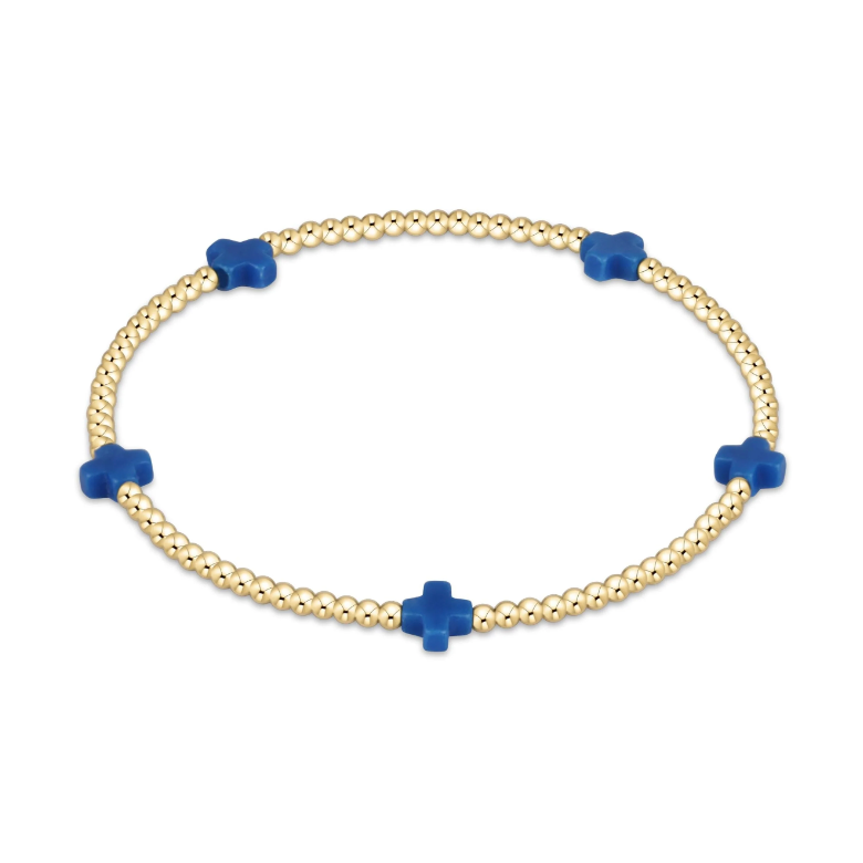 Gold beaded bracelet with five blue cross charms