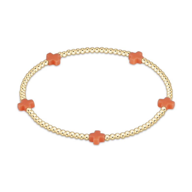 Gold beaded stretch bracelet with four orange cross charms