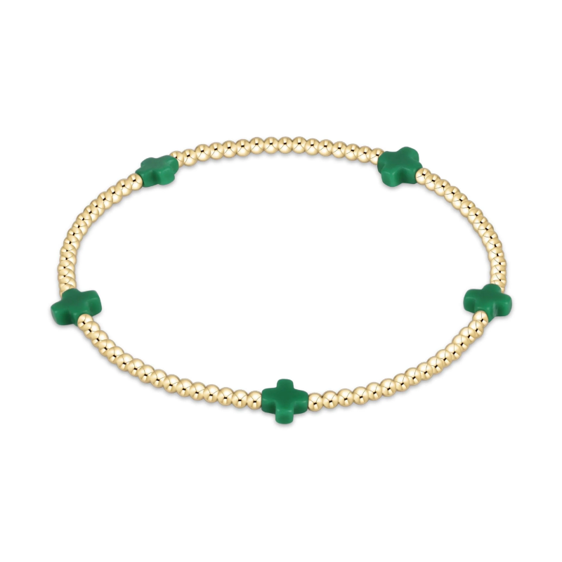 Gold beaded stretch bracelet with five green cross charms