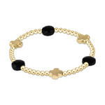 Gold beaded stretch bracelet with three faceted black onyx stones and three polished gold cross charms