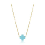 Minimalist gold chain necklace featuring a small light blue cross pendant centered on a white studio background