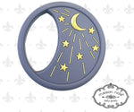 Silicone teether by Maison Nola baby goods a dark grey circular baby good featuring a prominent golden crescent moon and eight golden stars with radiating lines, designed with an ergonomic integrated handle