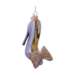 Glass Christmas ornament shaped like a high-heeled shoe, sparkling in silver and gold, featuring an embellished bow of tiny gold and silver stones, and topped with a small gold star hanger