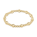 Jewelry a shimmering gold beaded bracelet featuring alternating small and large polished spheres on a clean white background