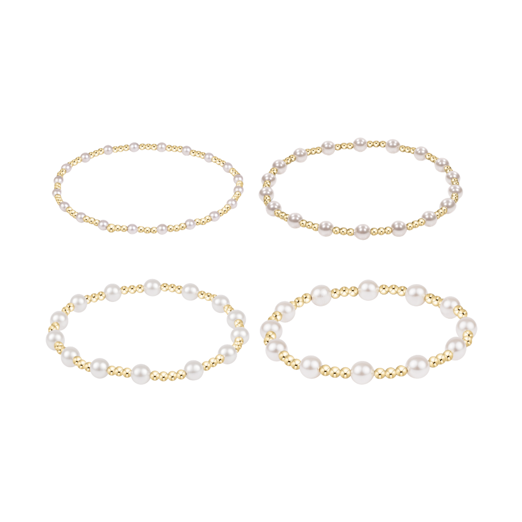 Four stretch bracelets with varying sizes of gold beads and white pearls