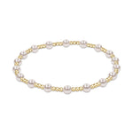 Stretch bracelet featuring alternating white pearls and small gold beads
