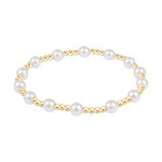 Stretch bracelet featuring alternating gold beads and white pearls