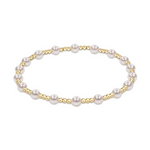 Jewelry elegant stretch bracelet featuring lustrous white spherical pearls alternating with smaller shiny golden round beads