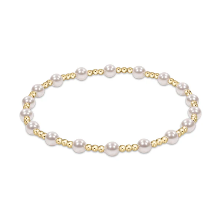 Jewelry elegant stretch bracelet featuring lustrous white spherical pearls alternating with smaller shiny golden round beads